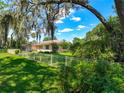Charming ranch-style home with mature trees and meticulously maintained lawn at 966 N Ronald Reagan Blvd, Longwood, FL 32750