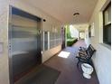 Hallway featuring an elevator, mailboxes, and bench seating, offering convenience and accessibility at 501 W Old Us Highway 441 # C201, Mount Dora, FL 32757