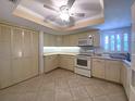 Charming kitchen with ample cabinets, tile floors, and updated appliances at 501 W Old Us Highway 441 # C201, Mount Dora, FL 32757