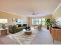 Bright living room with a large window, ceiling fan, and neutral decor at 501 W Old Us Highway 441 # C201, Mount Dora, FL 32757