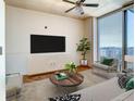 Spacious living room featuring hardwood floors and large windows at 155 S Court Ave # 2107, Orlando, FL 32801