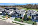 Luxury community featuring multiple homes with gray roofs at 3016 Kensington Ave, Davenport, FL 33837