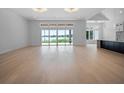 Bright living room boasts a wall of windows offering expansive waterfront views and light hardwood flooring at 260 Deer Isle Dr, Winter Garden, FL 34787