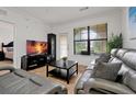 Living room with gray couches, coffee table, and TV at 904 Charo Pkwy # 518, Davenport, FL 33897