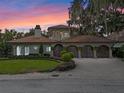 Stunning waterfront home with a beautiful facade and landscaping at 800 W 2Nd Ave, Windermere, FL 34786