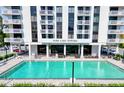 A large swimming pool is shown in front of the Park Lake Towers, with lounge chairs and seating areas nearby at 400 E Colonial Dr # 203, Orlando, FL 32803