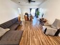 Comfortable living area featuring an open floor plan, modern flooring, and natural light from the balcony at 4865 Cypress Woods Dr # 2204, Orlando, FL 32811