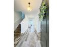 Inviting entryway with wood-look tile flooring and stairs leading to the upper level at 224 Trinity Ridge Cir, Davenport, FL 33897