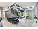 Modern living room with a decorative wall, sleek furniture, and sliding glass doors at 224 Trinity Ridge Cir, Davenport, FL 33897