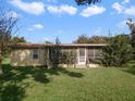 Light yellow single story home with screened porch at 12 Lee St, Ocoee, FL 34761