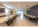 Open-concept dining area boasts modern lighting and ample seating for large gatherings at 4189 Lana Ave, Davenport, FL 33897