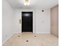Condominium elevator features neutral paint and tile, and handicap signage at 1110 W Ivanhoe Blvd # 6, Orlando, FL 32804