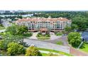 An attractive full exterior shot of the condominium featuring mature landscaping at 1110 W Ivanhoe Blvd # 6, Orlando, FL 32804