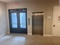 Hallway with elevator and exit access at 7740 Sandy Ridge Dr # 217, Reunion, FL 34747