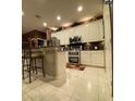 Modern kitchen features stainless steel appliances, a breakfast bar, and white cabinetry at 466 Pepin Dr, Orlando, FL 32825