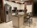 Well-equipped kitchen with stainless steel appliances, granite countertops, a breakfast bar, and ample cabinet space at 466 Pepin Dr, Orlando, FL 32825