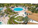 Community pool area with a clubhouse, fountain, and multiple pools at 1539 Flange Dr, Davenport, FL 33896