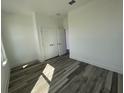 Well-lit bedroom with modern flooring and double closet doors at 14046 Scarlet Aster Aly, Winter Garden, FL 34787