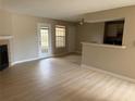 Bright living room featuring wood floors, fireplace, and access to the patio at 5635 Devonbriar Way # 103, Orlando, FL 32822