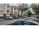 Exterior of the apartments features a tan color scheme and ample parking spaces for residents and visitors at 13103 Mulberry Park Dr # 824, Orlando, FL 32821