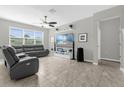 Cozy living room featuring modern furniture, tile floors, and a large window for natural light at 3318 Current Ave, Winter Garden, FL 34787