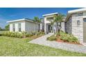 Stylish home with a brick-accented exterior and lush tropical landscaping at 839 Waterfern Trail Dr, Auburndale, FL 33823