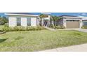 Well-manicured front lawn and landscaping accent this modern home's exterior at 839 Waterfern Trail Dr, Auburndale, FL 33823