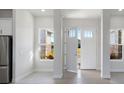 Bright and airy entryway with hardwood floors and open view at 208 Snowy Orchid Way, Lake Alfred, FL 33850
