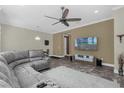 Spacious living room with a large sectional sofa and flat-screen TV at 637 Pavia Loop, Lake Mary, FL 32746