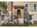 Inviting townhome entrance with a covered entryway and wrought-iron railing at 637 Pavia Loop, Lake Mary, FL 32746