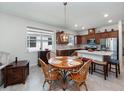 Cozy dining area featuring a wooden table and a view of the modern kitchen at 2542 Cliff Way, St Cloud, FL 34771