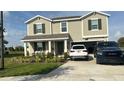 Two-story house with a two-car garage and landscaped lawn at 4499 Magnolia Ridge Ct, Kissimmee, FL 34746