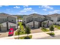 Street view of modern townhomes, showcasing stone accents and a nearby water park at 1065 Splash Shot Pl # 1801, Davenport, FL 33896