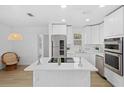 Modern kitchen with white cabinets, stainless steel appliances, and an island at 36 Camellia Dr, Ormond Beach, FL 32176