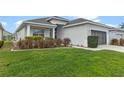 One-story house with lush green lawn and neutral siding at 145 Lewis Dr, Davenport, FL 33837