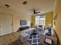 Bright living room with comfy seating, large window, and stylish decor at 12825 Madison Pointe Cir # 205, Orlando, FL 32821