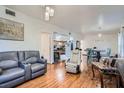 Spacious living room featuring hardwood floors, modern lighting and comfortable seating area at 1817 W Grant St, Orlando, FL 32805
