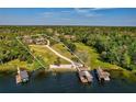 Aerial view of waterfront property highlighting its expansive lot, dock, boat house and lake access at 208 Green Lake Cir, Longwood, FL 32779