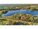 Aerial view shows a house on a large lot near a lake at 39250 Forest Dr, Eustis, FL 32736