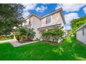 Two-story house with a landscaped yard at 608 Abaco Ct, Kissimmee, FL 34746