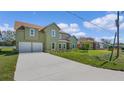 Two-story house with green exterior, driveway, and landscaping at 1929 Sipes Ave, Sanford, FL 32771