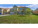 Two-story house with green exterior and a spacious lawn at 1929 Sipes Ave, Sanford, FL 32771
