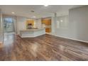 Open-concept living space with hardwood floors and seamless transition to the kitchen at 148 Blue Stone Cir, Winter Garden, FL 34787