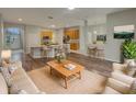 Spacious living room open to the kitchen, featuring wood floors, neutral walls, and modern decor at 148 Blue Stone Cir, Winter Garden, FL 34787