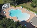 Aerial view of a community pool with lounge chairs and shade structures at 5692 Camilla St, St Cloud, FL 34771