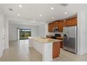 Spacious kitchen featuring a large island, stainless steel appliances, and tile flooring at 410 Annabelle Way, Davenport, FL 33837