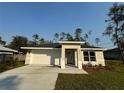 Newly built home with a white garage door and a neatly landscaped front yard at 1645 6Th Ave, Deland, FL 32724