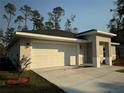 New construction home with a white garage door and nicely landscaped front yard at 1645 6Th Ave, Deland, FL 32724