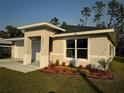 Newly built one-story house featuring a white garage door and well-maintained landscaping at 1645 6Th Ave, Deland, FL 32724