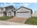 Charming single-Gathering home featuring a spacious two-car garage and a well-manicured lawn at 687 Campo Ln, Davenport, FL 33837